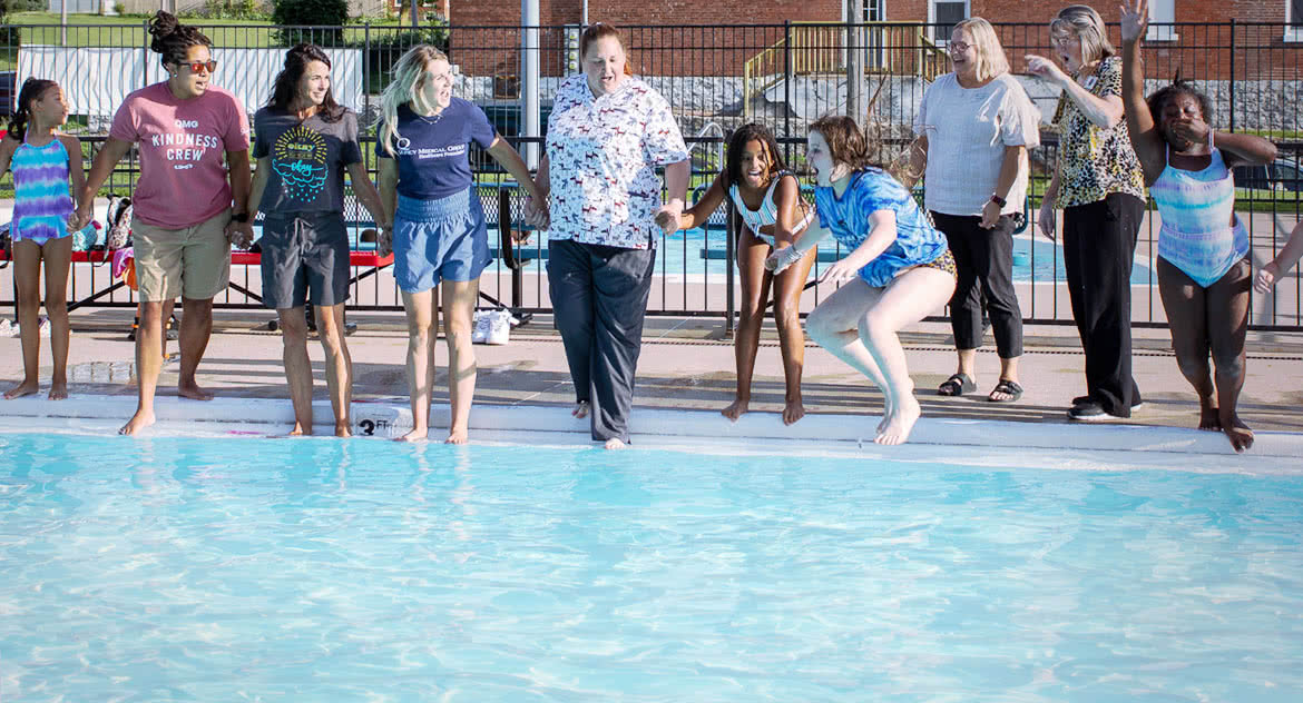 Jumping-in-Swimming-Pool line of people jumping into the swimming pool holding hands